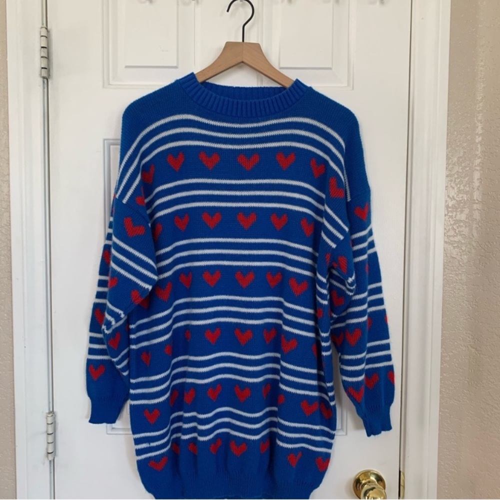 Woman’s blue winter sweater with red hearts